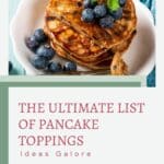 Image of a stack of pancakes topped with blueberries and mint on a plate, with the text "the ultimate list of pancake toppings galore" by alphagal.